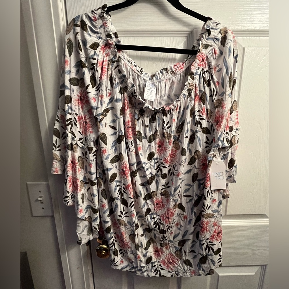 White blouse with flowers, bell sleeves, and elastic around neckline